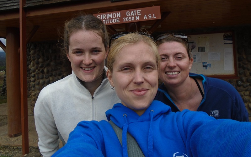 Emma, Jenny, and Amanda reach one of the overnight stations on the slopes of Mount Kenya