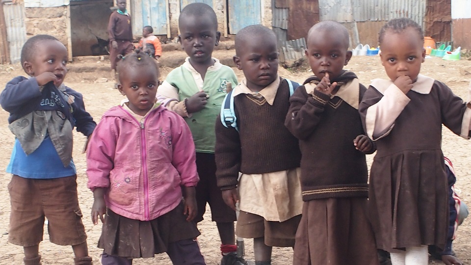 children in the Nairobi slums wear whatever clothes they can get their hands on as they cannot afford to buy new